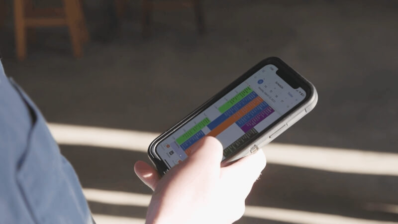 contractor using mobile CRM app to manage jobs and scheduling in the field