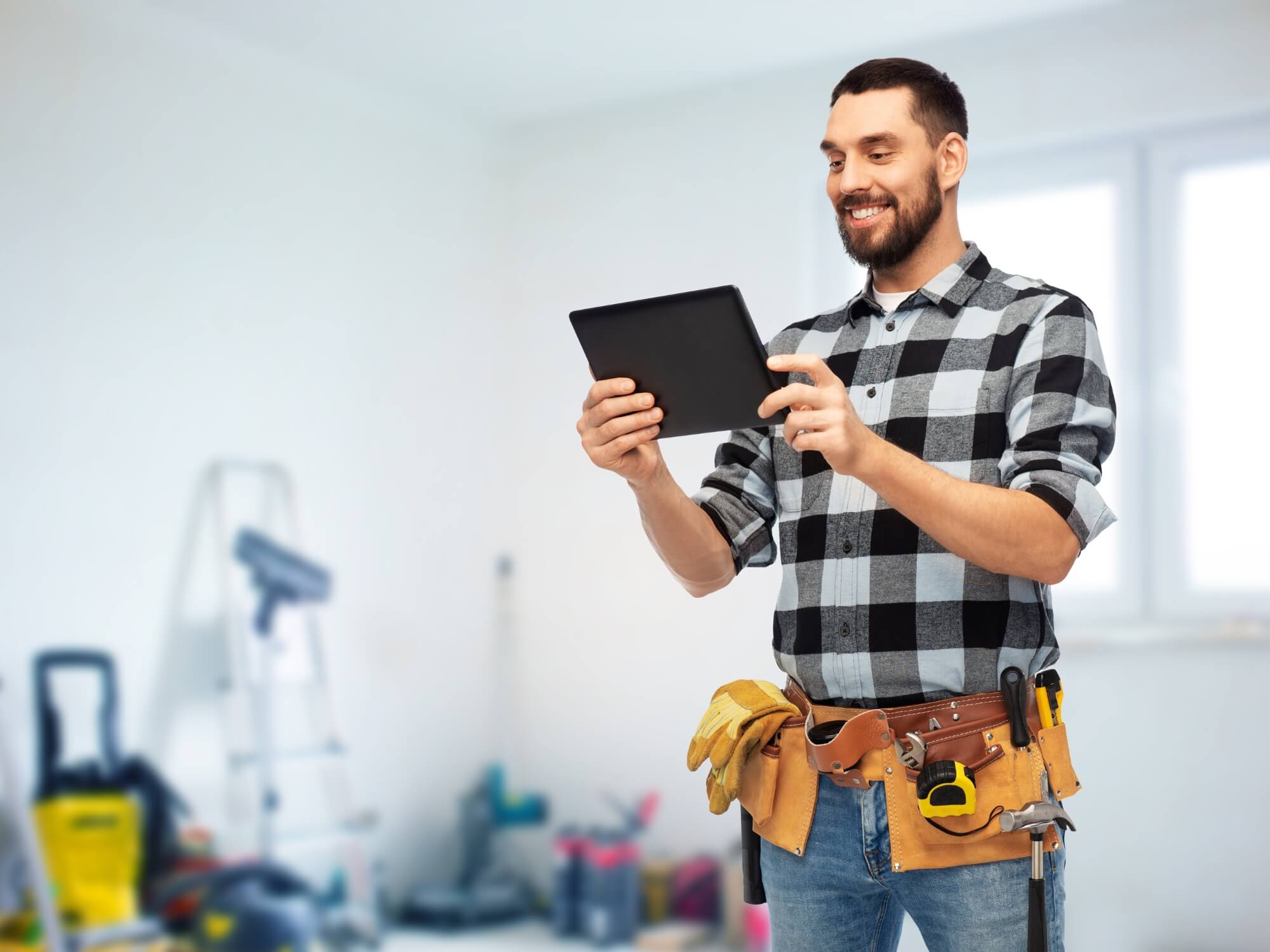 contractor using Jobber field service CRM on tablet in service truck