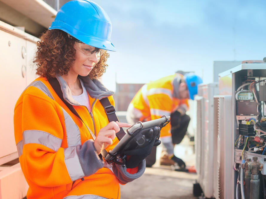 Field service technician using mobile software for scheduling, dispatch, and service operations